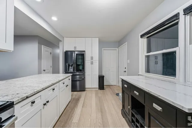 a kitchen with stainless steel appliances granite countertop a stove a sink and a refrigerator
