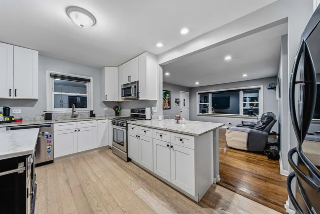 a large kitchen with stainless steel appliances granite countertop a large center island and a sink