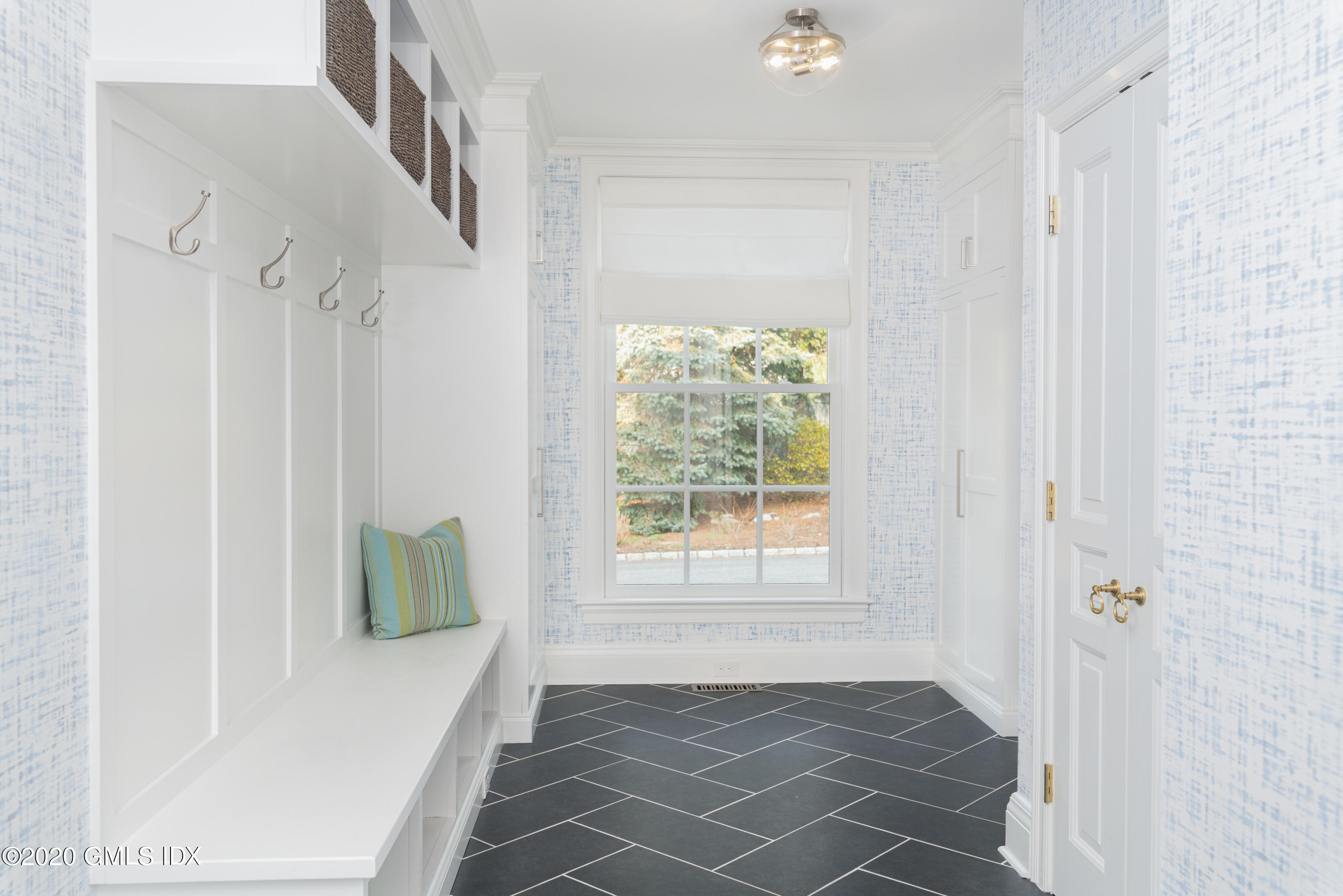 390 Round Hill Road Greenwich, CT 06831 - Photo 13 of 31 a view of an entryway with wooden floor and a rug