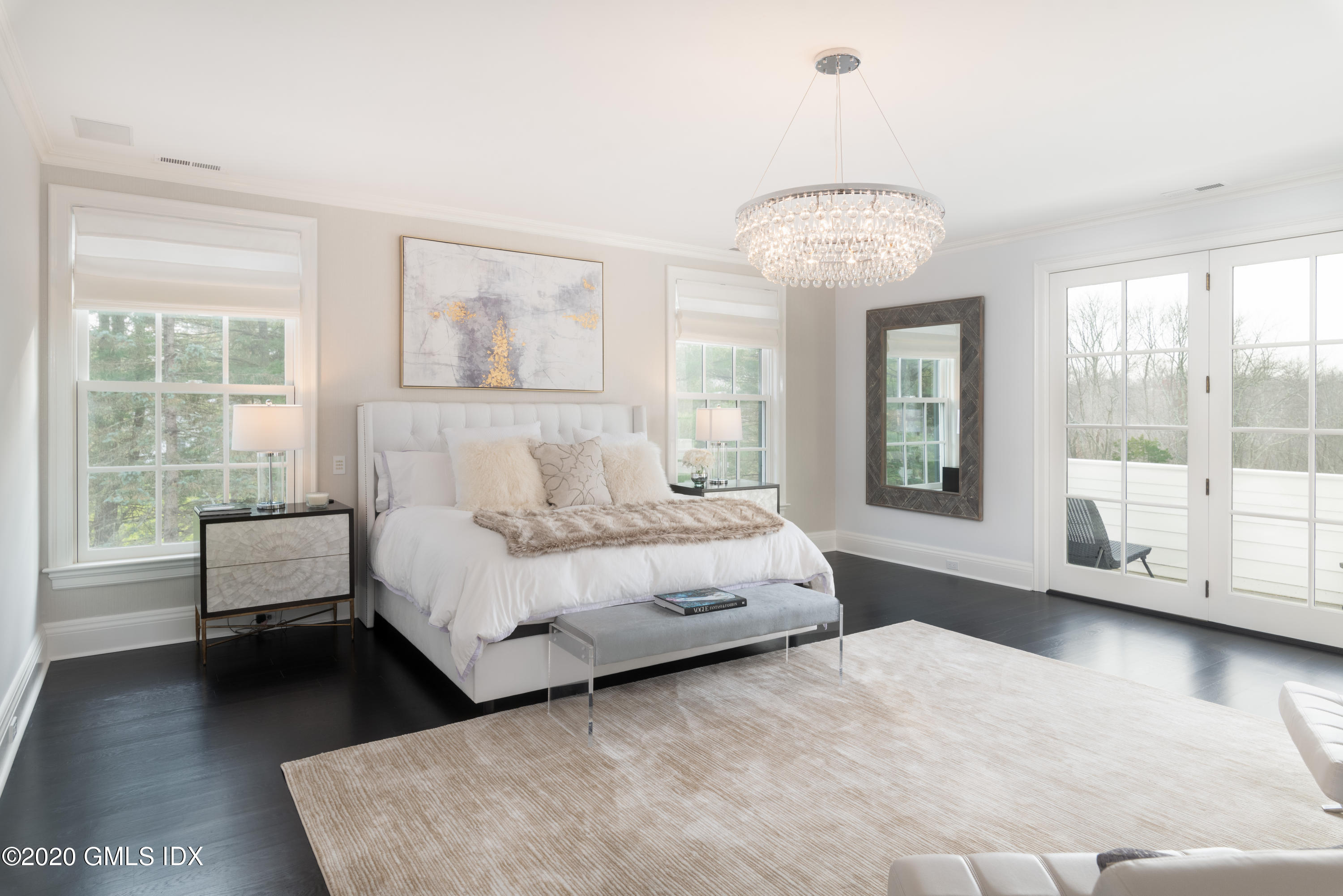 390 Round Hill Road Greenwich, CT 06831 - Photo 15 of 31 a spacious bedroom with a bed and a large window