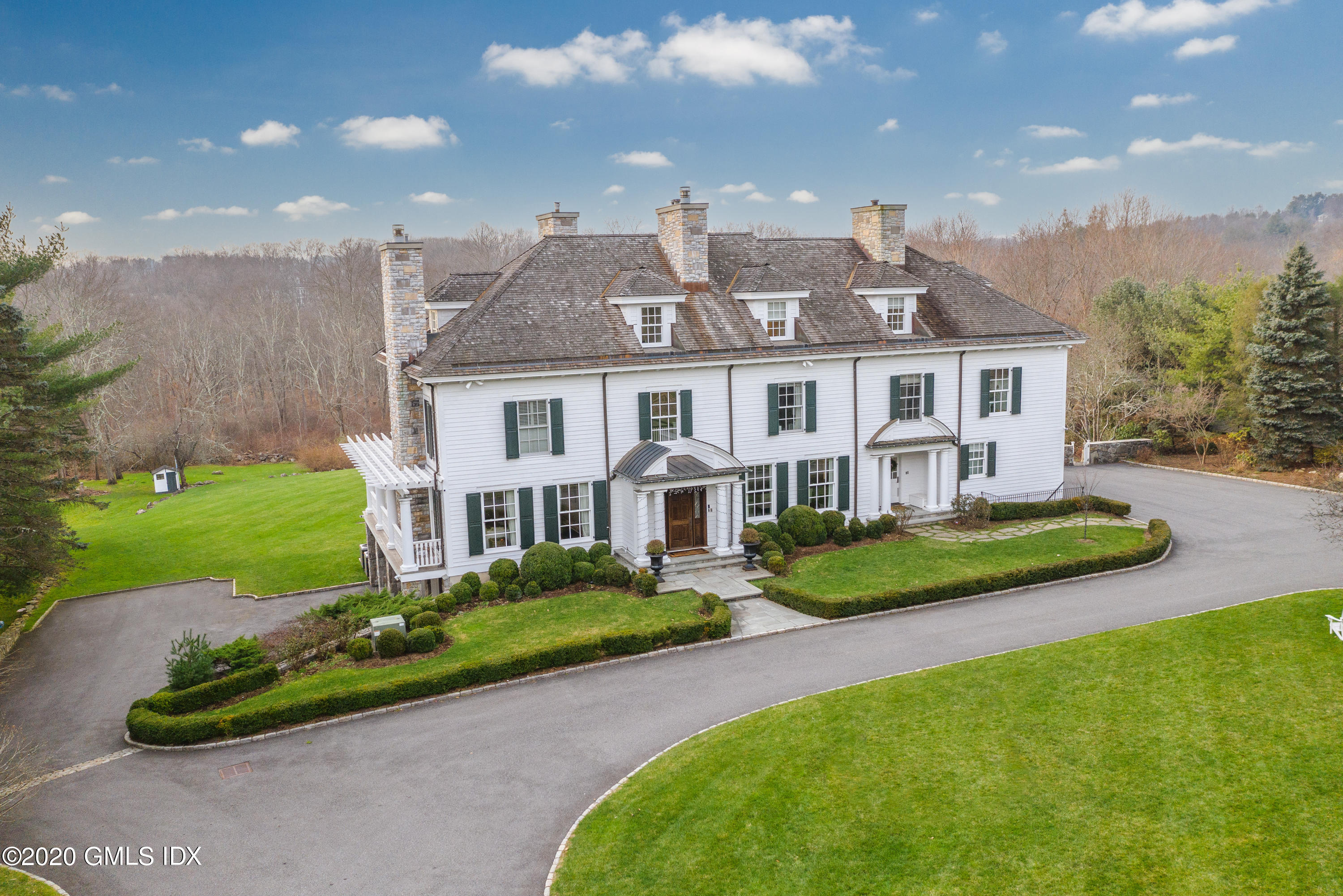 390 Round Hill Road Greenwich, CT 06831 - Photo 2 of 31 a front view of a house with garden