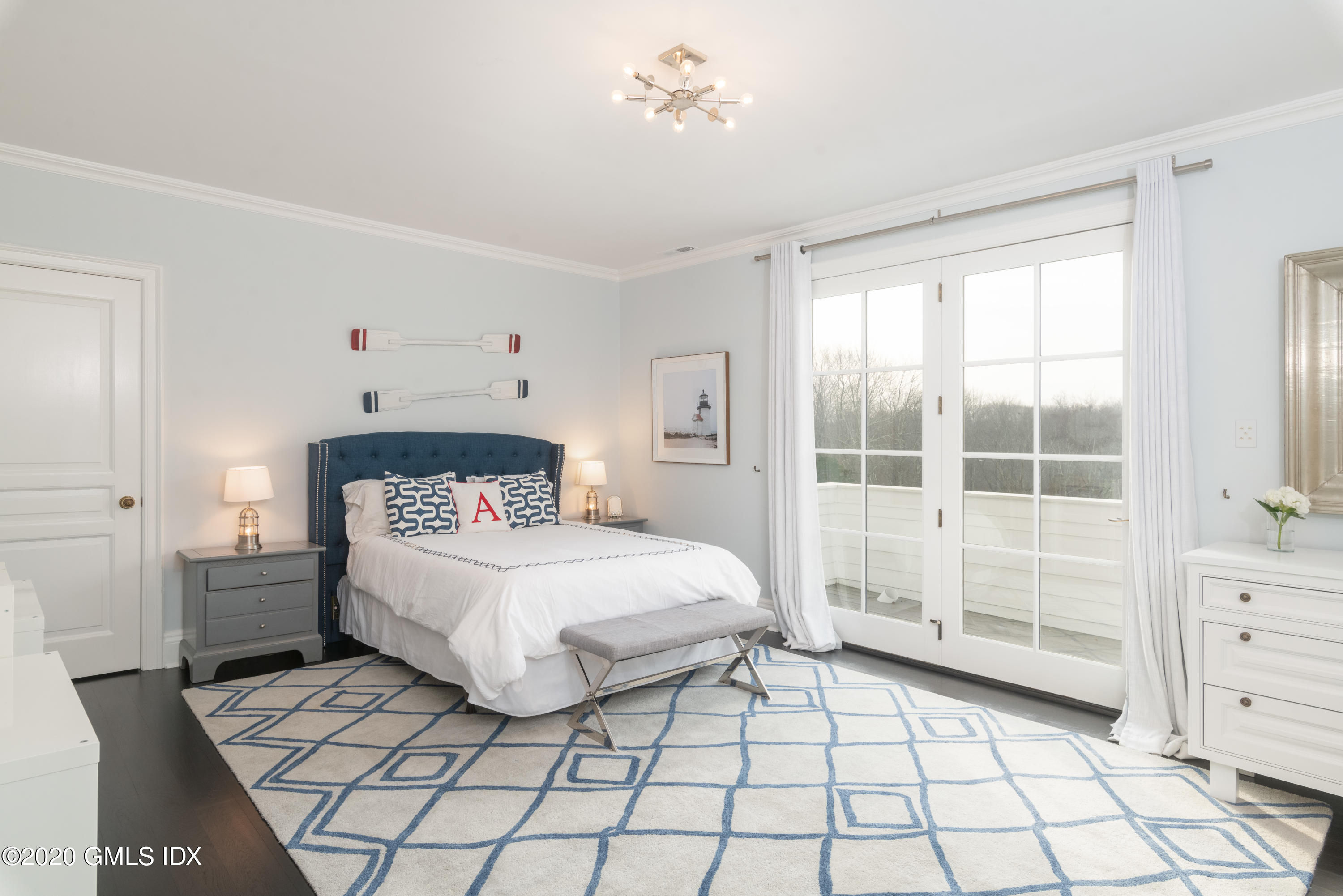 390 Round Hill Road Greenwich, CT 06831 - Photo 21 of 31 a bedroom with a bed and a window