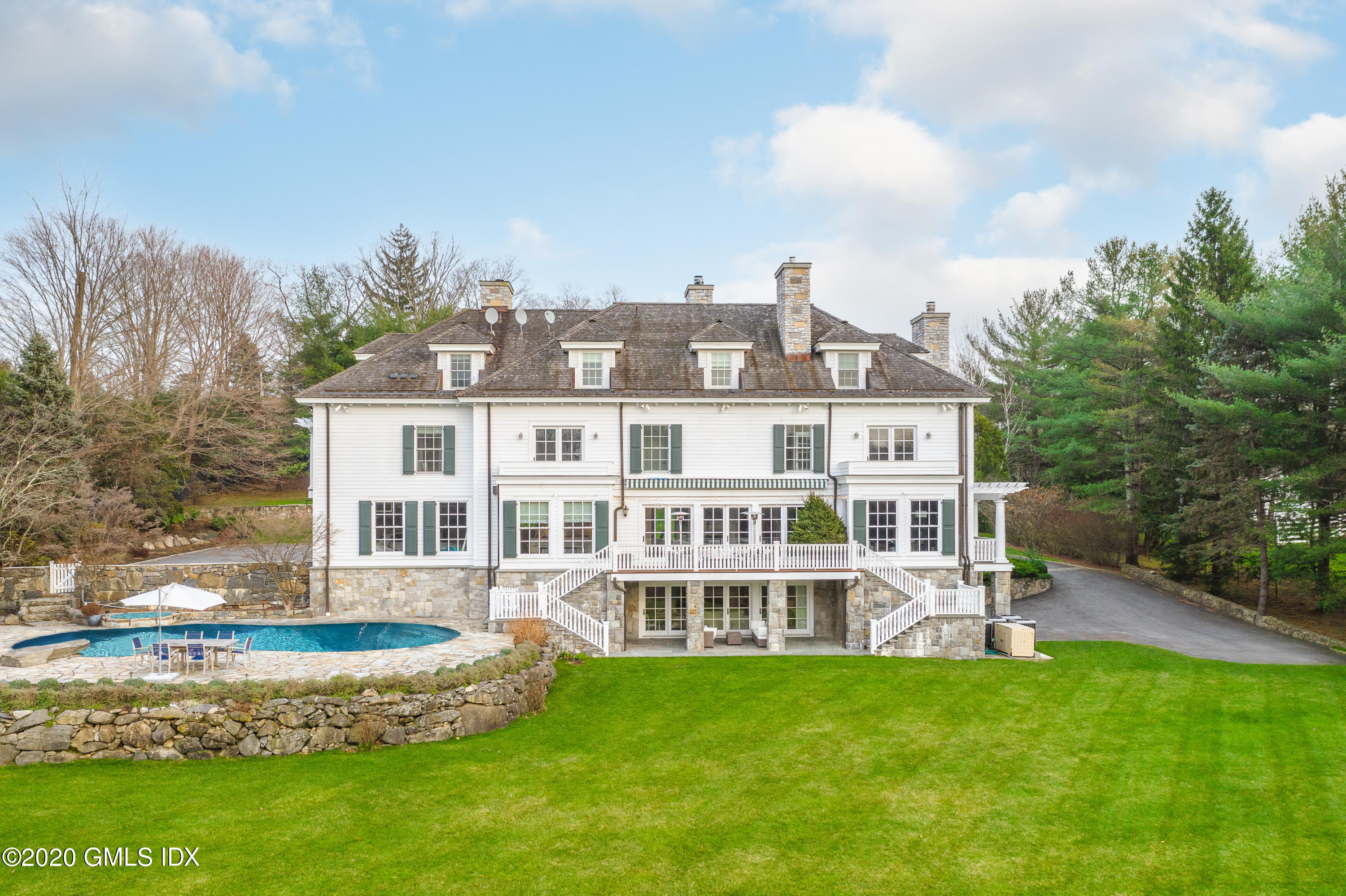 390 Round Hill Road Greenwich, CT 06831 - Photo 30 of 31 a front view of a house with a yard