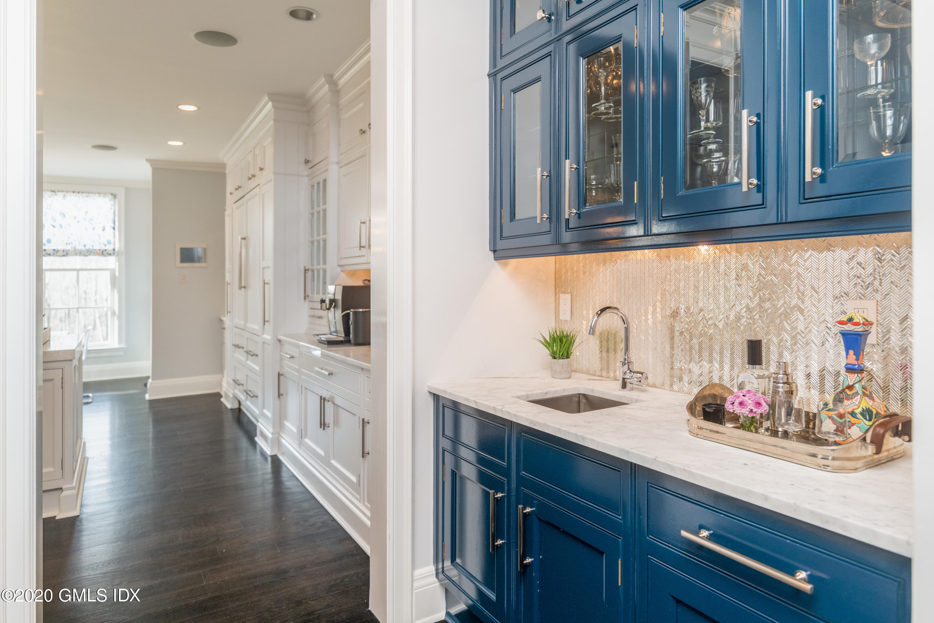390 Round Hill Road Greenwich, CT 06831 - Photo 9 of 31 a kitchen with stainless steel appliances white cabinets and wooden floor