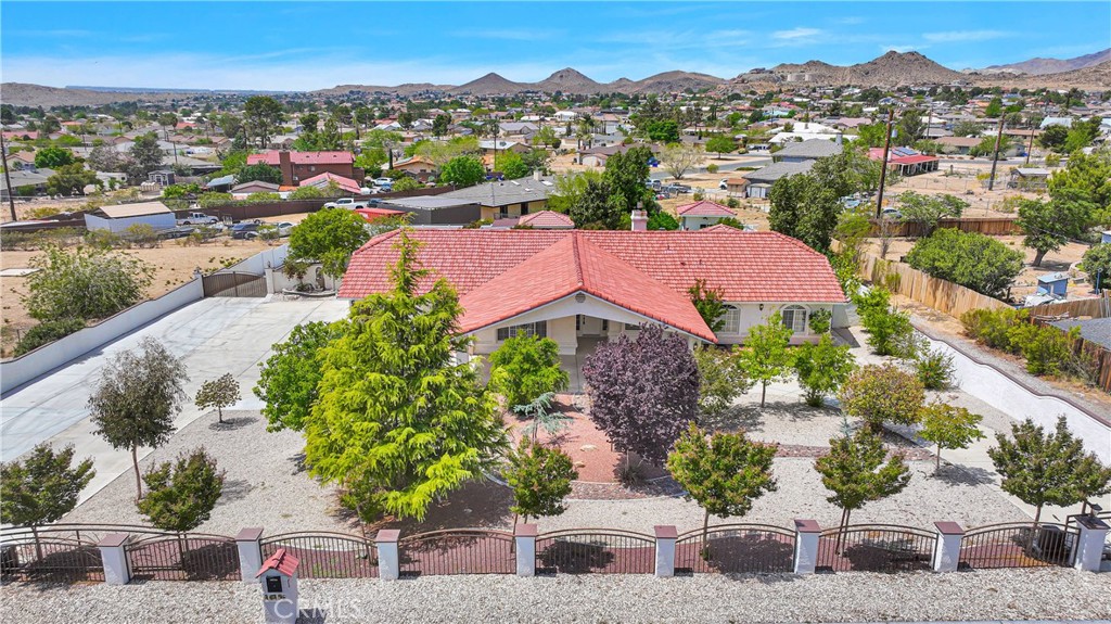 16158 Rimrock Road Apple Valley, CA 92307 - Photo 1 of 1 an aerial view of a houses with a street and green space