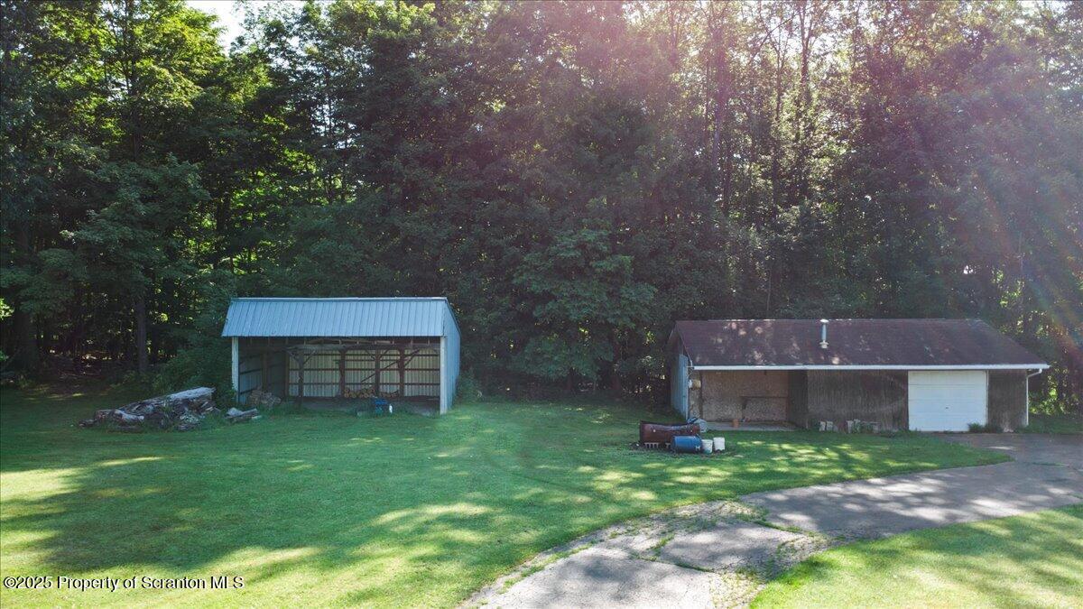 4089 State Rte 2073 Susquehanna, PA 18847 - Photo 13 of 63 a backyard of a house with plants and large tree