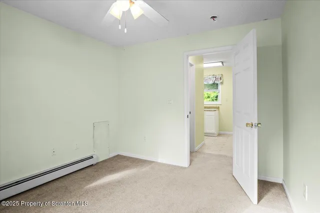 a kitchen with a refrigerator a sink and white cabinets