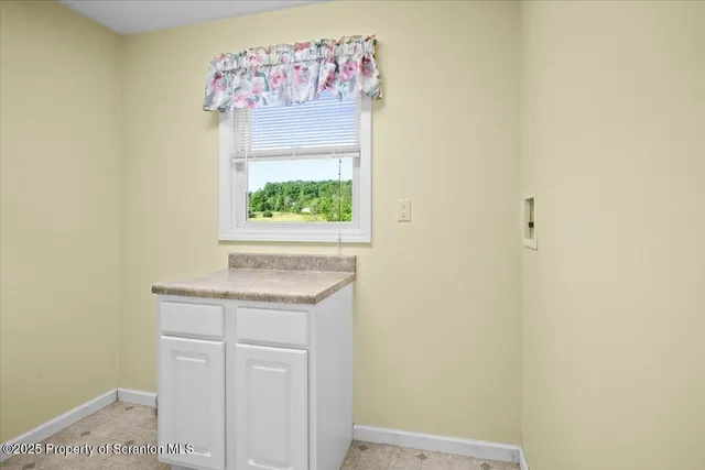 a large kitchen with granite countertop a sink a counter space appliances and cabinets