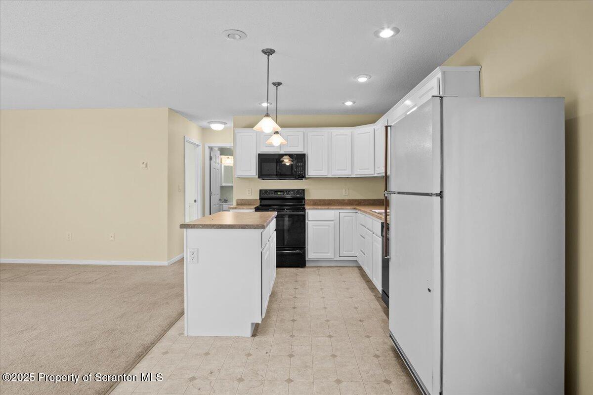 4089 State Rte 2073 Susquehanna, PA 18847 - Photo 25 of 63 a kitchen with a refrigerator a sink and white cabinets