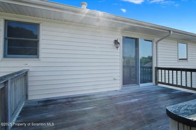 a view of a hallway with a chandelier fan