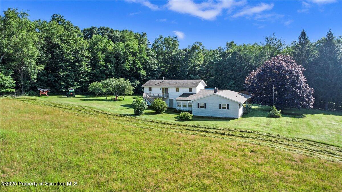 4089 State Rte 2073 Susquehanna, PA 18847 - Photo 4 of 63 a house with green field in front of it