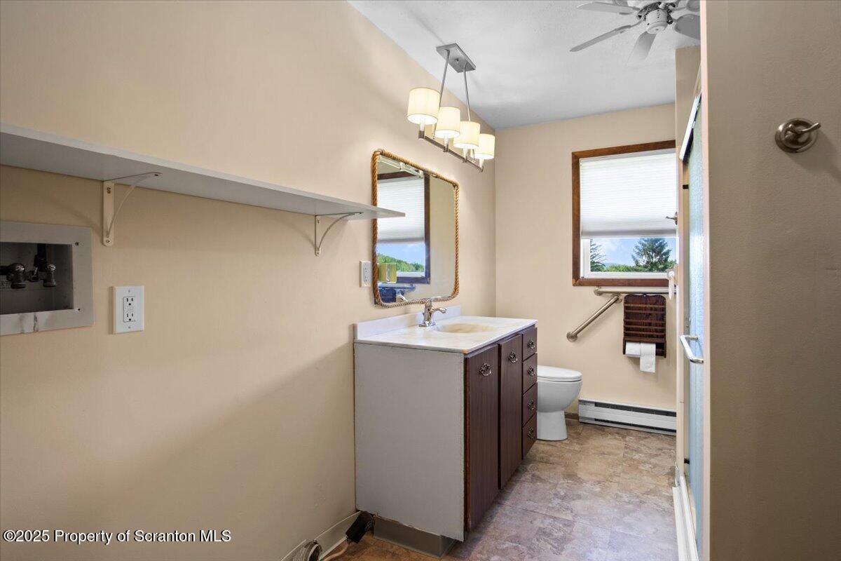 4089 State Rte 2073 Susquehanna, PA 18847 - Photo 58 of 63 a bathroom with a sink a toilet and mirror