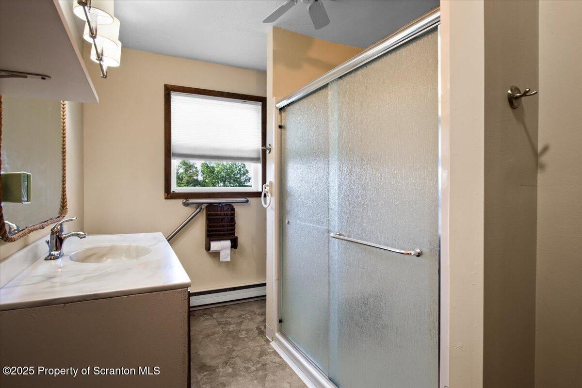 4089 State Rte 2073 Susquehanna, PA 18847 - Photo 60 of 63 a bathroom with a shower sink and mirror