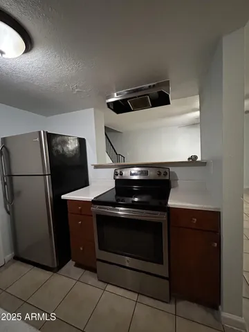 a stove top oven sitting inside of a kitchen