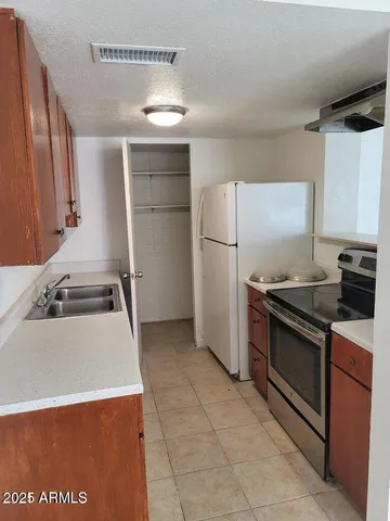 a kitchen with a refrigerator sink and stove