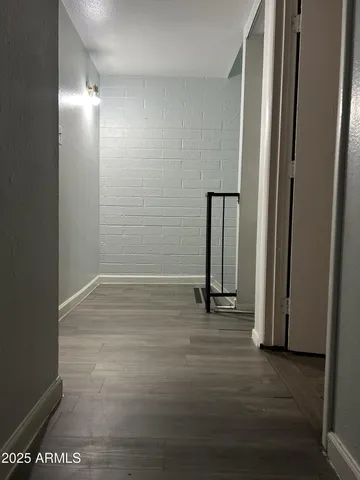 an empty room with wooden floor and a door