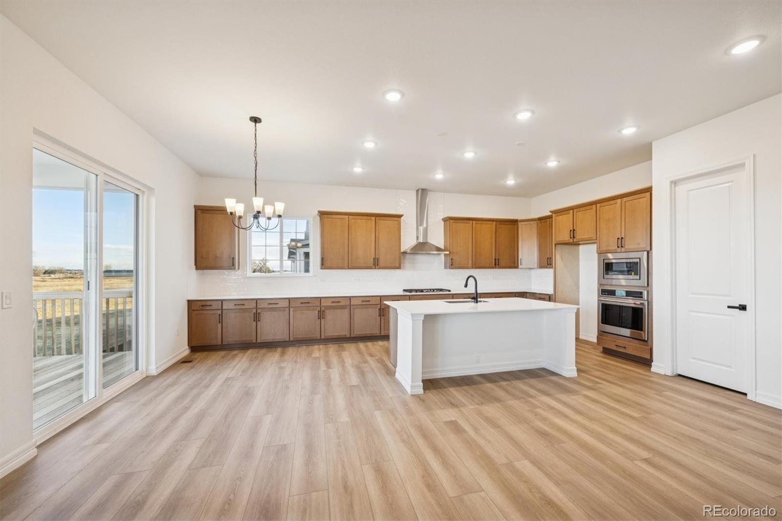 1168 Weller Street Timnath, CO 80547 - Photo 11 of 24 a large kitchen with a lot of counter space and stainless steel appliances