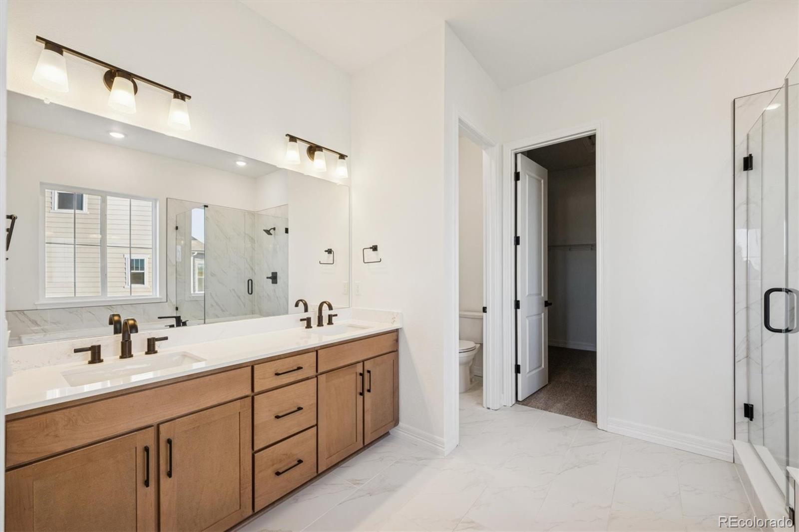 1168 Weller Street Timnath, CO 80547 - Photo 15 of 24 a spacious bathroom with a double vanity sink mirror and double