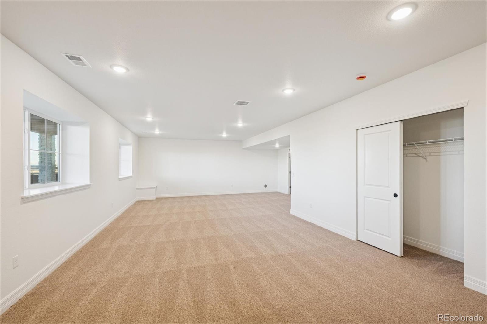 1168 Weller Street Timnath, CO 80547 - Photo 17 of 24 an empty room with windows and closet