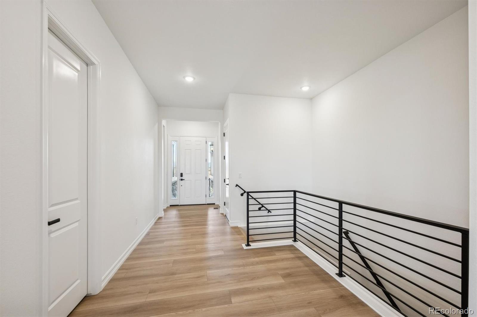1168 Weller Street Timnath, CO 80547 - Photo 2 of 24 a view of a hallway with wooden floor