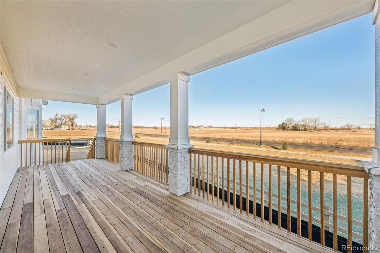 1168 Weller Street Timnath, CO 80547 - Photo 22 of 24 a view of a balcony with wooden floor
