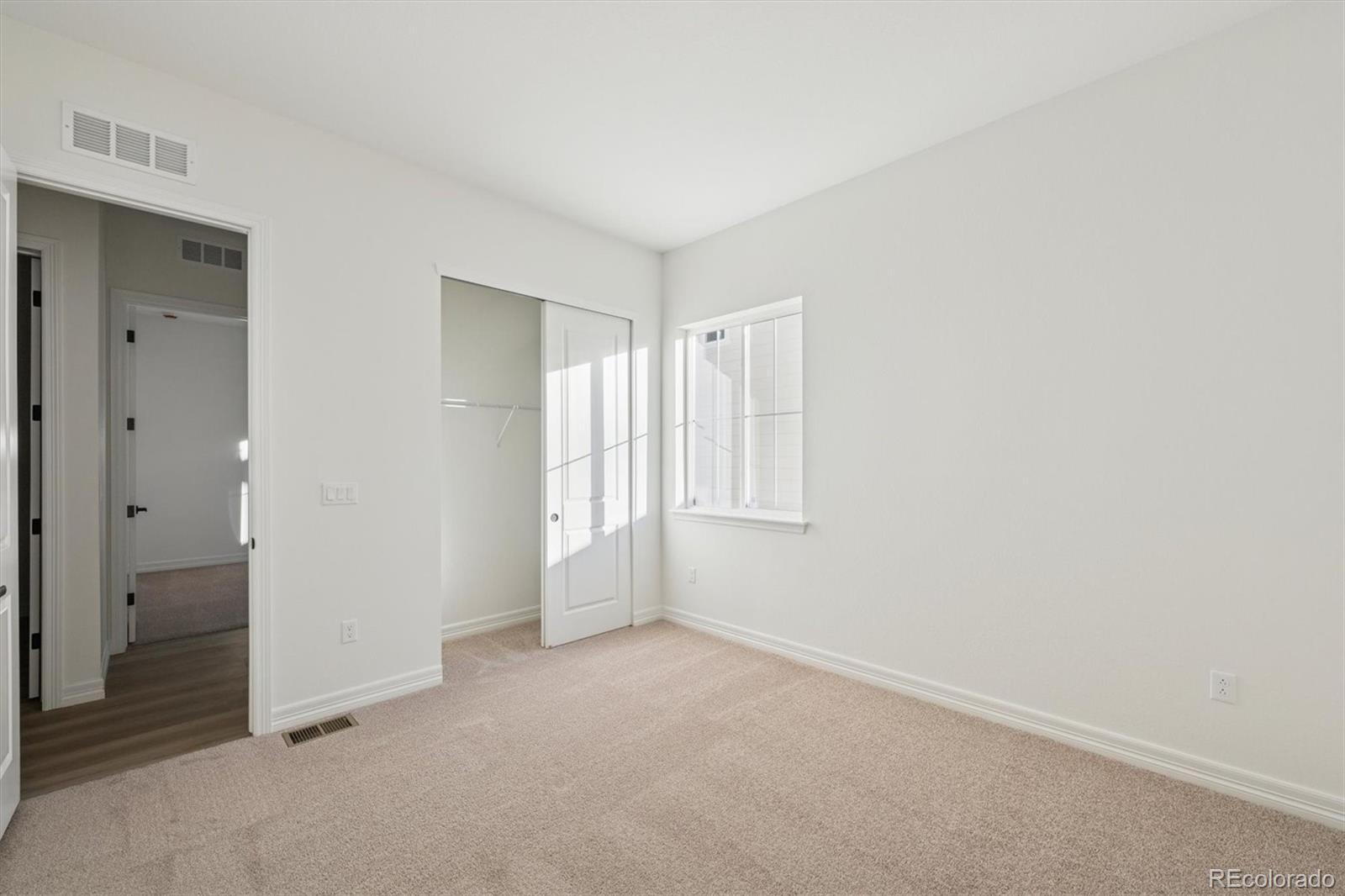 1168 Weller Street Timnath, CO 80547 - Photo 7 of 24 a view of an empty room and window
