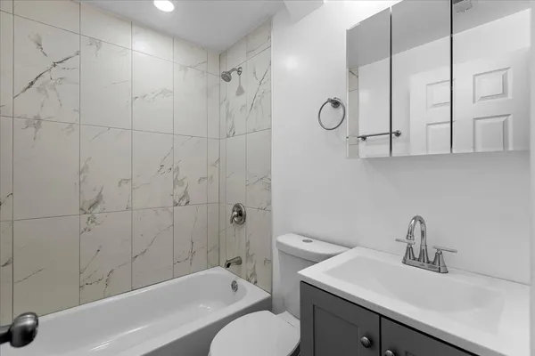 a bathroom with a sink toilet a mirror and shower