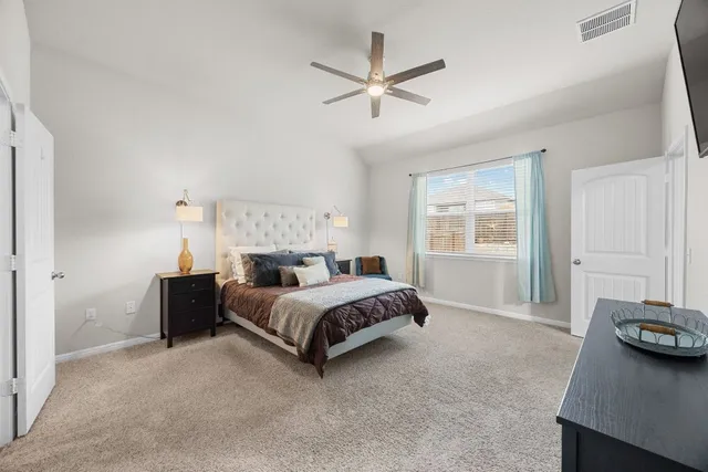 a bed room with a bed and a window