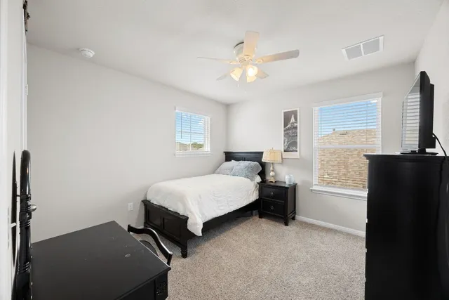a bedroom with a bed and a chandelier