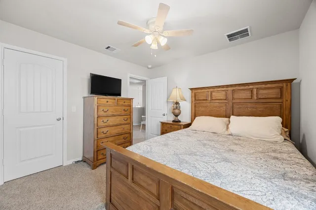 a bedroom with a bed and a television