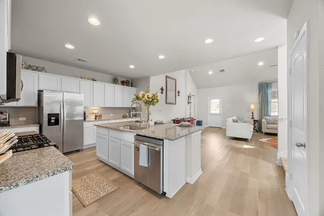 a kitchen with sink stove and refrigerator
