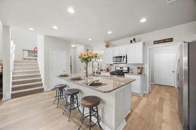 a kitchen with appliances a sink and cabinets