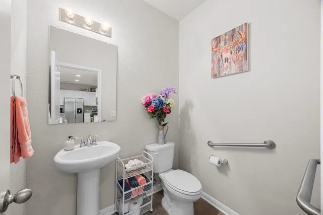 a bathroom with a toilet sink and mirror