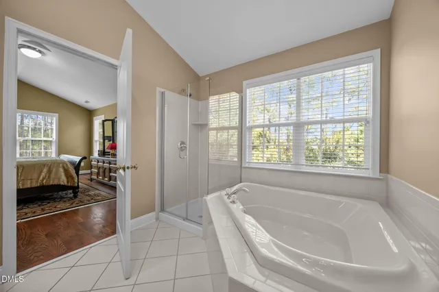 a white bath tub sitting next to a shower
