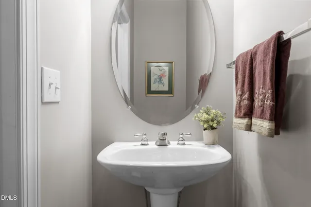 a bathroom with a sink a toilet and mirror