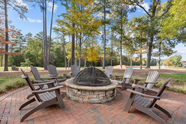 a view of a building with sitting area and garden