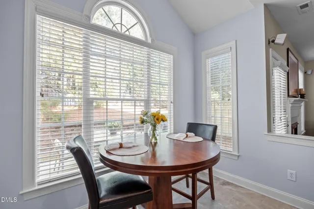 a living room with furniture wooden floor and a floor to ceiling window