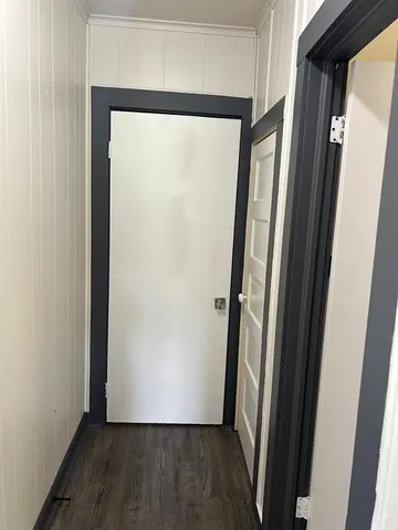 a view of front door with wooden floor