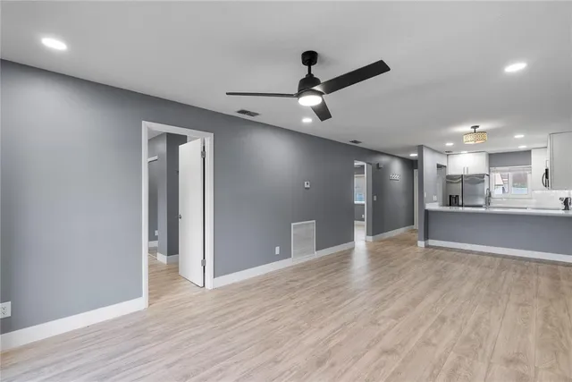 a view of a kitchen with a sink and wooden floor