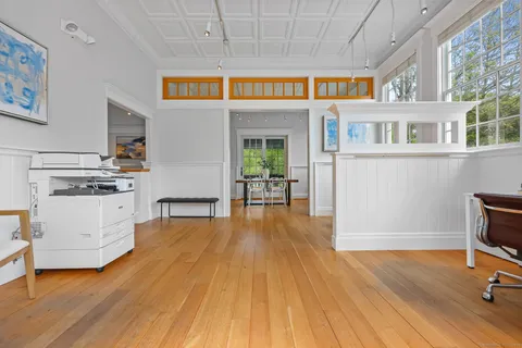 a view of a livingroom with furniture hardwood floor and a ceiling fan