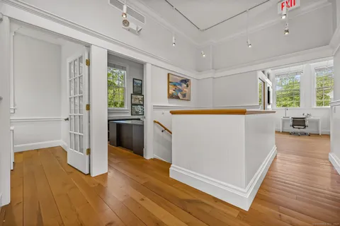 a kitchen with granite countertop a refrigerator and wooden floor