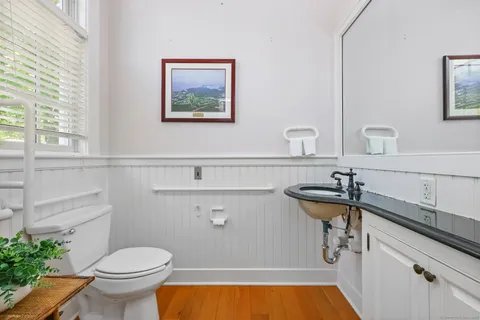 a bathroom with a sink a toilet and a mirror