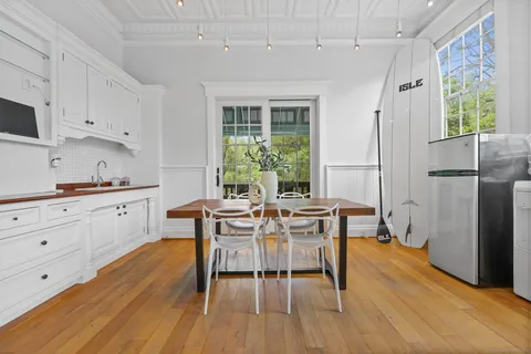 a view of a dining room with furniture window and wooden floor