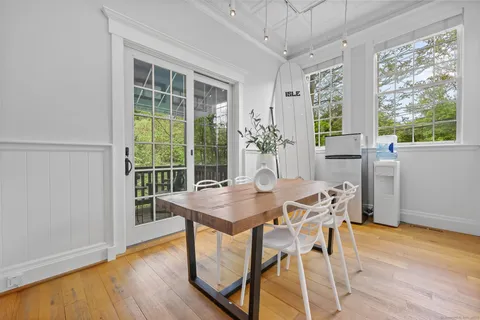 a view of a dining room with furniture window and wooden floor