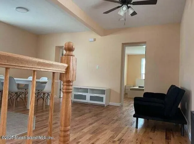 a view of a room that has a table and chairs in it