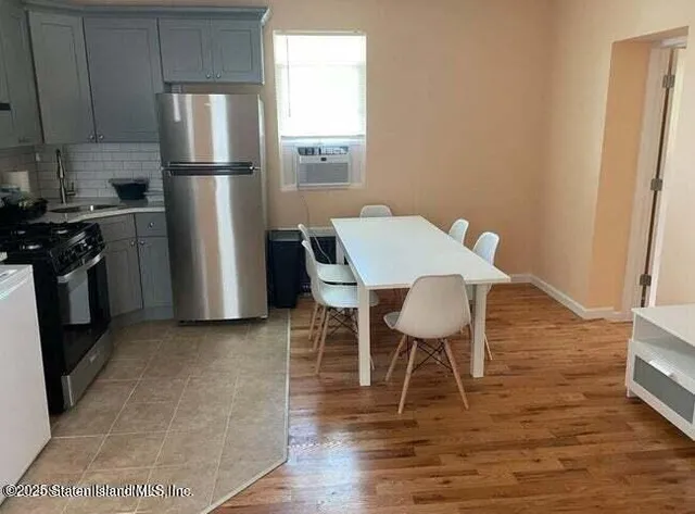 a kitchen with a stove a refrigerator and a table