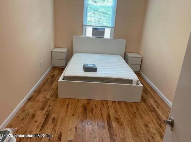173 Clove Road Staten Island, NY 10310 - Photo 8 of 11 a room with a bed