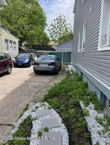 a view of a patio with table and chairs with wooden fence