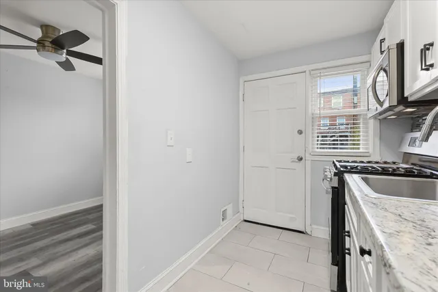 a kitchen with a sink and a refrigerator
