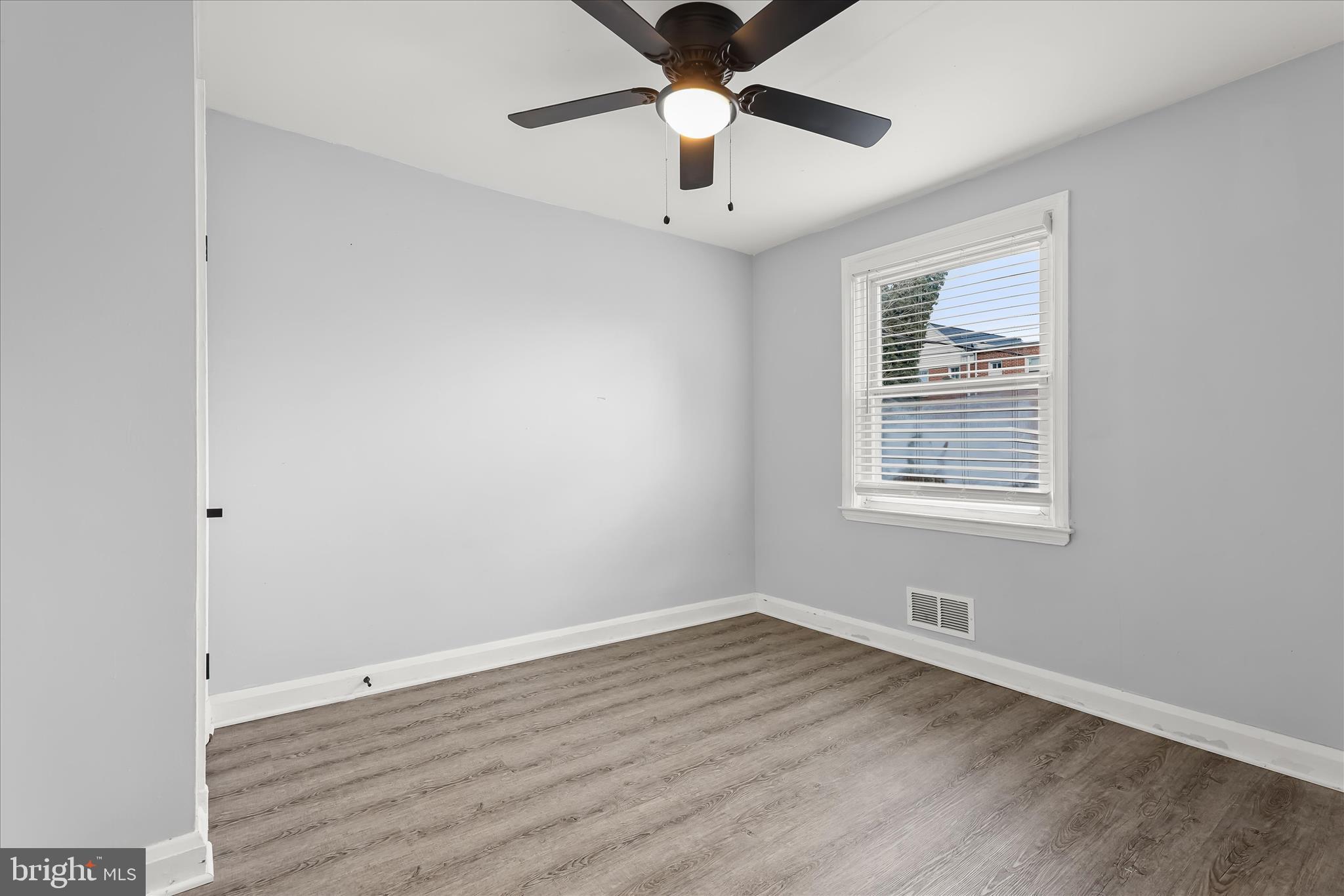 4352 Eldone Road Baltimore, MD 21229 - Photo 15 of 27 wooden floor in an empty room with a window